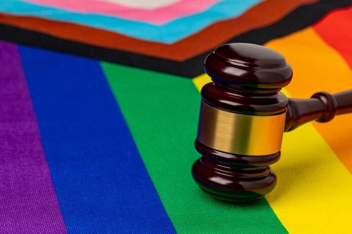 shutterstock_2315935709.jpg featured image Gavel on rainbow and pride flags overlapping