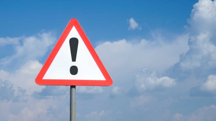 shutterstock_1783779719.jpg featured image Triangle warning sign with exclamation mark against sky.