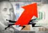 Red arrow breaking through hundred dollar bill