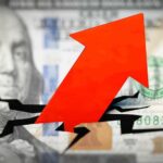 Red arrow breaking through hundred dollar bill