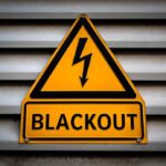 Yellow blackout warning sign with lightning bolt symbol