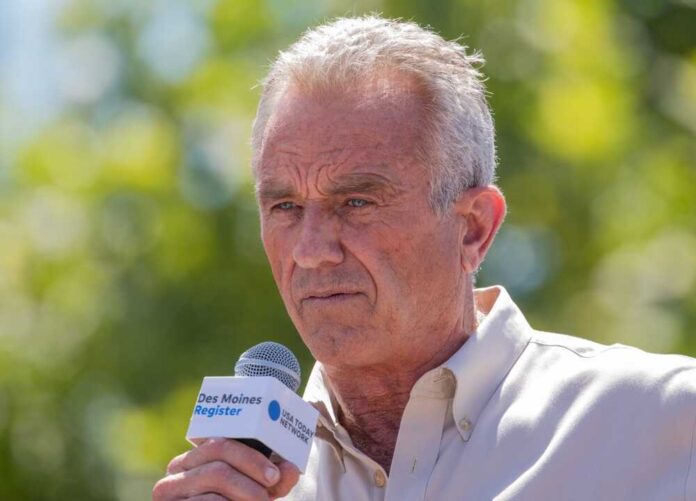 shutterstock_2346739537.jpg featured image Robert F. Kennedy Jr. speaking into a microphone.