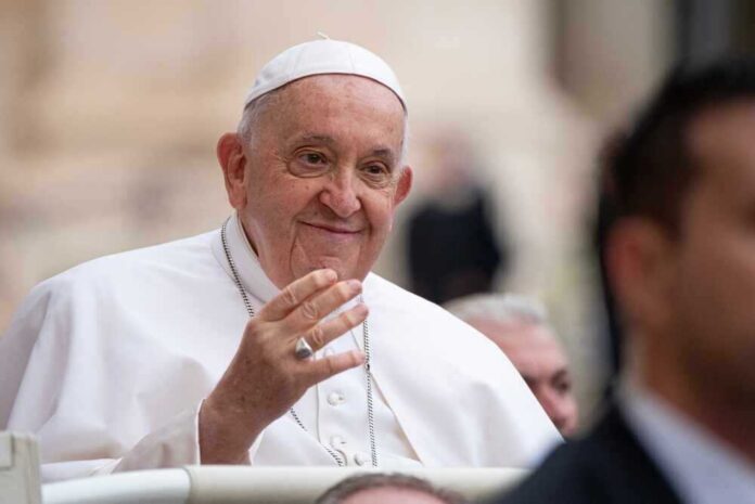 shutterstock_2380566915.jpg featured image Pope Francis smiling and greeting people.
