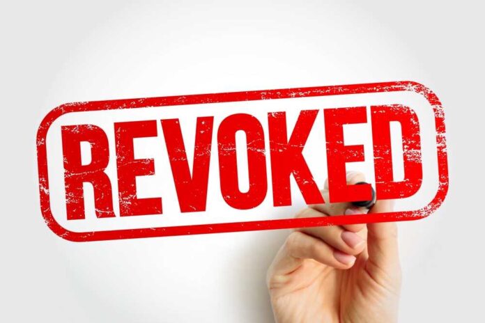 shutterstock_2398290259.jpg featured image Hand holding a marker writing revoked stamp