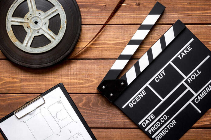 shutterstock_539523673.jpg featured image Film reel, clapperboard, and storyboard on wooden table.