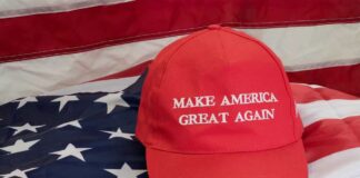 Red Make America Great Again hat on American flag