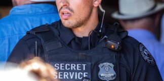 Secret Service officer in uniform with equipment visible.