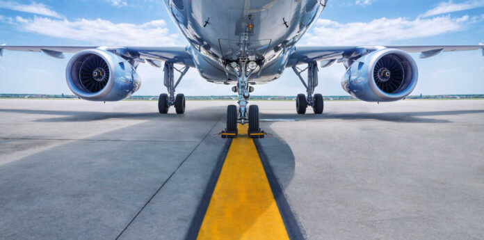 shutterstock_637037008.jpg featured image Low angle view of airplane on runway.