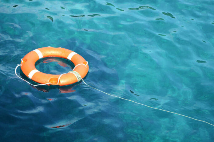 shutterstock_1252068862.jpg featured image Orange life ring floating in clear blue water.