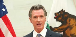 Gavin Newsom speaking at podium.