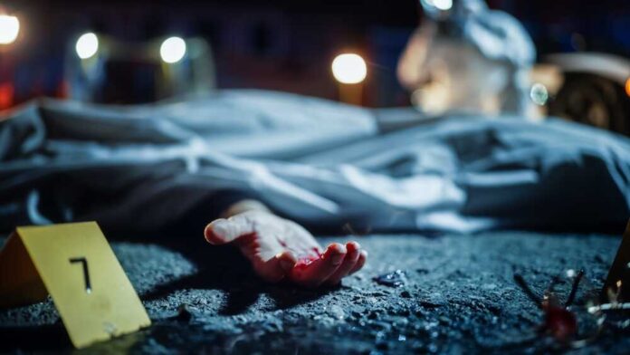 shutterstock_2230645915.jpg featured image Crime scene with covered body and hand exposed.