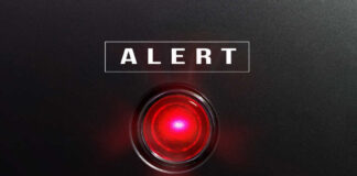 Red alert light on black background