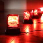 Terrifying Amoeba Hits Popular Lake – Child Dies Red emergency lights on dark floor illuminating the area