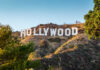 Hollywood Sign on a green hillside, sunny day.