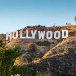 SUDDEN DEATH Shocks Hollywood! Hollywood Sign on a green hillside, sunny day.