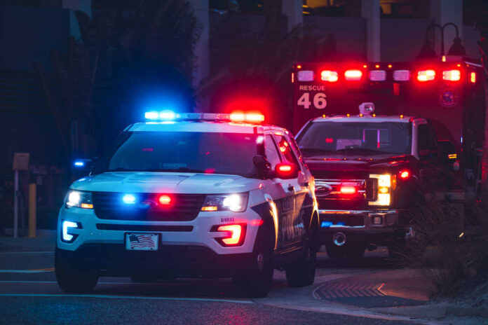 shutterstock_2002708079.jpg featured image Police car and ambulance with flashing lights nighttime