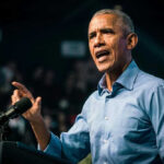 Barack Obama speaks at podium.