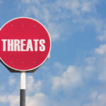 BOMB Threat PANIC on Flight! Emergency Landing Red sign with the word threats against sky