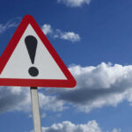 Instructor Killed by Freak Lightning — 14 Injured! Warning sign with exclamation mark against sky
