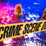 Crime scene tape with blurred evidence markers