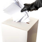 Ballot Box BOMBSHELL: Election Fraud Caught on Camera!? Gloved hand placing multiple papers in a ballot box