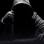 Knife-Wielding Attacker Takes Down Selfless Hero Person in dark hoodie holding a knife ominously