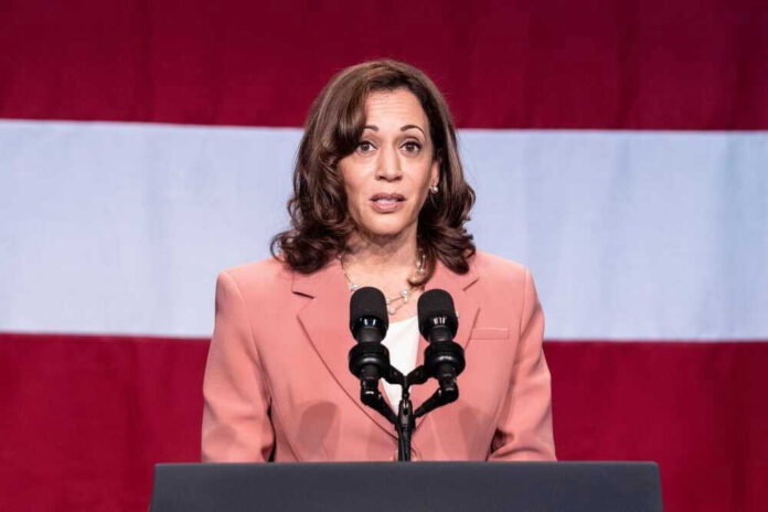 A woman speaks at a podium with microphones.