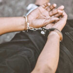Person in handcuffs with hands behind back