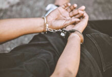 Person in handcuffs with hands behind back