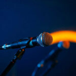 Close-up of a microphone on a stand, dark background
