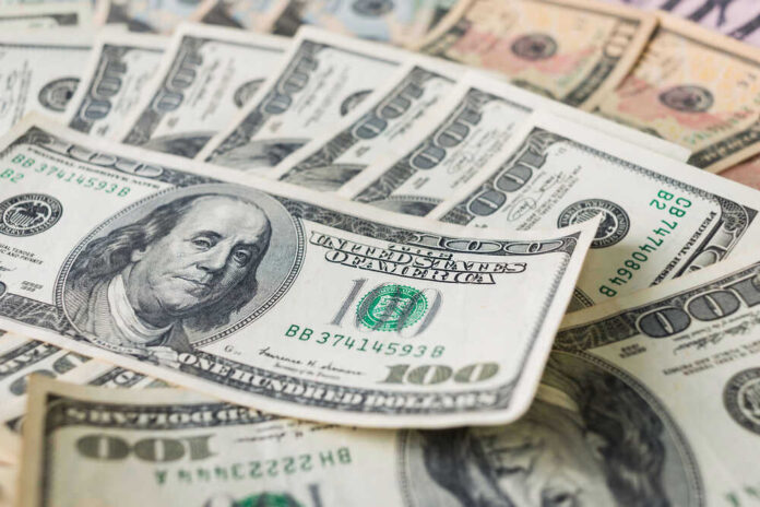 Stacks of various U.S. dollar bills