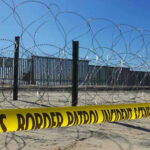 Human Smuggling Ring EXPOSED — Border Chaos Deepens Border patrol tape and barbed wire fence