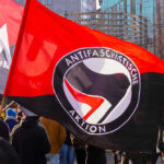 Trump DESIGNATES Antifa Terrorist Organization — MAGA Cheers Protest with Antifascist Action flags and people outdoors
