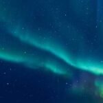 TONIGHT: Solar Blast Will Light Up the Sky A vibrant display of the northern lights in a starry night sky