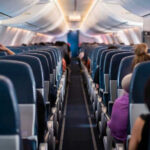 Airline Comfort Now Costs Extra!? Airplane interior with passengers seated mid-flight