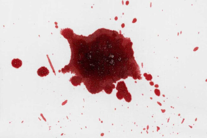 shutterstock_2439757693.jpg Red liquid splatter on a white background