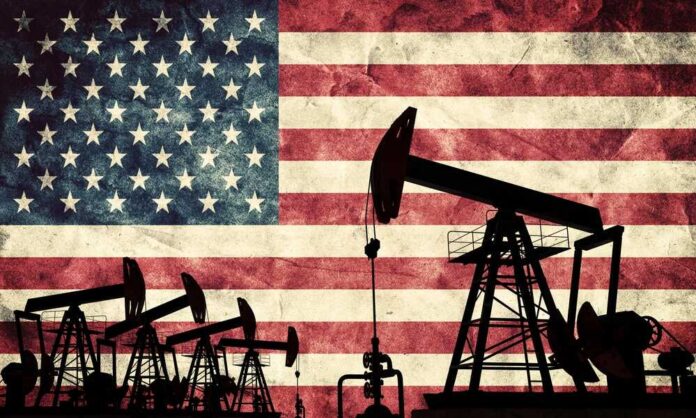 Silhouettes of oil pumps in front of a distressed American flag