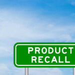 ALERT: Bacterial Contamination Forces Massive Recall Green sign with product recall text and sky background