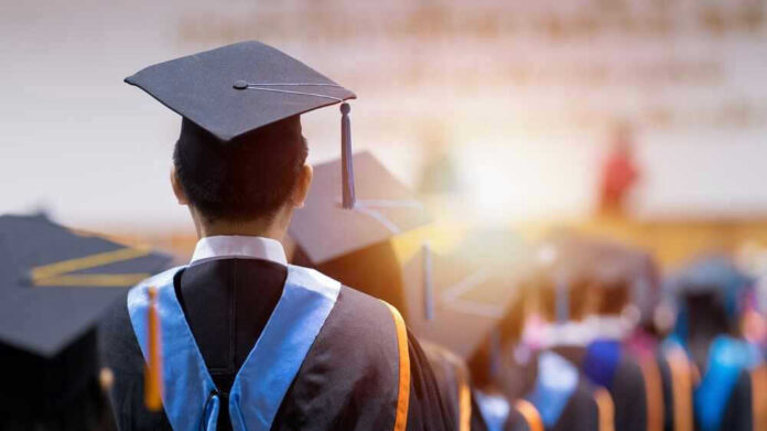 Students at graduation ceremony wearing caps and gowns.