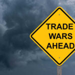 Japan-China Showdown: Trade War Explodes Yellow warning sign reads Trade Wars Ahead