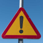 Cartel Boss FAKED Death — Lived Like King Triangular warning sign with exclamation mark.