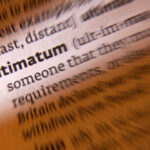 Trump UNLEASHES Nuclear Ultimatum Close-up of a dictionary page showing the definition of 'ultimatum'