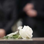 Chris Rea DIES – Christmas Icon GONE Forever A white rose placed on a surface during a funeral service
