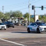 Two autonomous vehicles navigating an urban intersection
