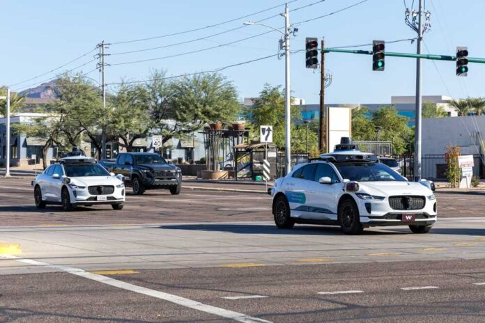 Two autonomous vehicles navigating an urban intersection