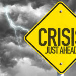 Cattle Crisis: Worst Shortage Since 2018 Yellow sign reading Crisis Just Ahead with stormy sky