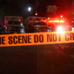 Hollywood Power Couple Found Dead Crime scene tape with emergency vehicles in background.