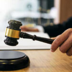 Judge Stops DHS: Evidence in Pretti Killing Gavel in judges hand about to strike.