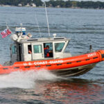 77-Year-Old Jumps Overboard: Coast Guard Scrambles U.S. Coast Guard boat speeding through water