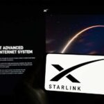 Musk’s Starlink Lights Up Venezuela — FREE Internet! A smartphone displaying the Starlink logo in front of a screen showing a space image